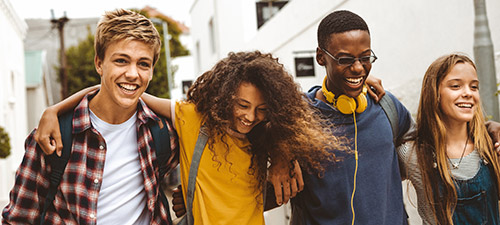 Group of Teenagers Smiling and Walking Together Group of Teenagers Smiling and Walking Together